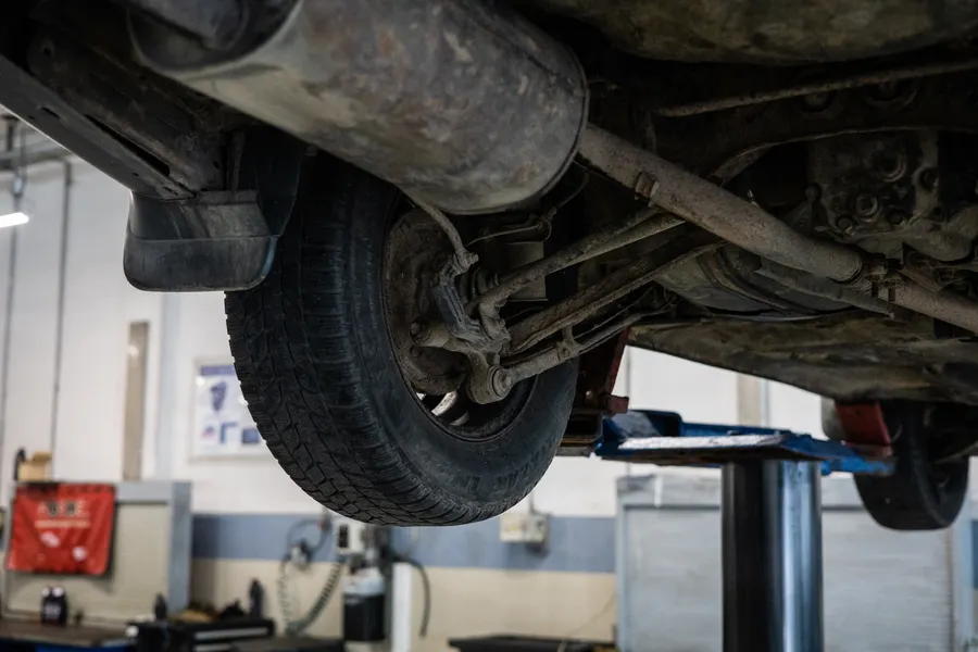 Vehicle undercarriage and suspension seen from below on a lift