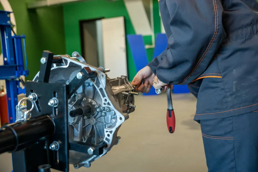 Mechanic working on a vehicle transmission